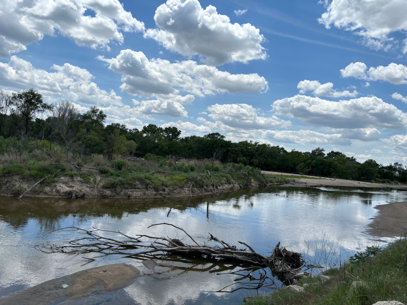 Sandy river bend under summer clouds